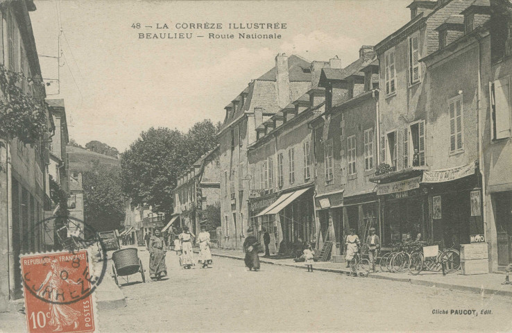 Beaulieu-sur-Dordogne : "48 - La Corrèze illustrée - Beaulieu - Route nationale". Commerces Paucot (horlogerie-optique et cycles-automobiles).
