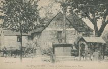 Saint-Augustin : "Saint-Augustin. - Croix et vieille maison sur la place". Métier à ferrer