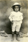 Portrait en pied d'un jeune enfant, en tenue coloniale.