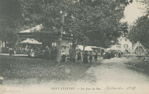 Saint-Exupéry-les-Roches : "Saint-Exupéry. - Un jour de fête.". Date mentionnée manuscrite, manèges, balançoires.